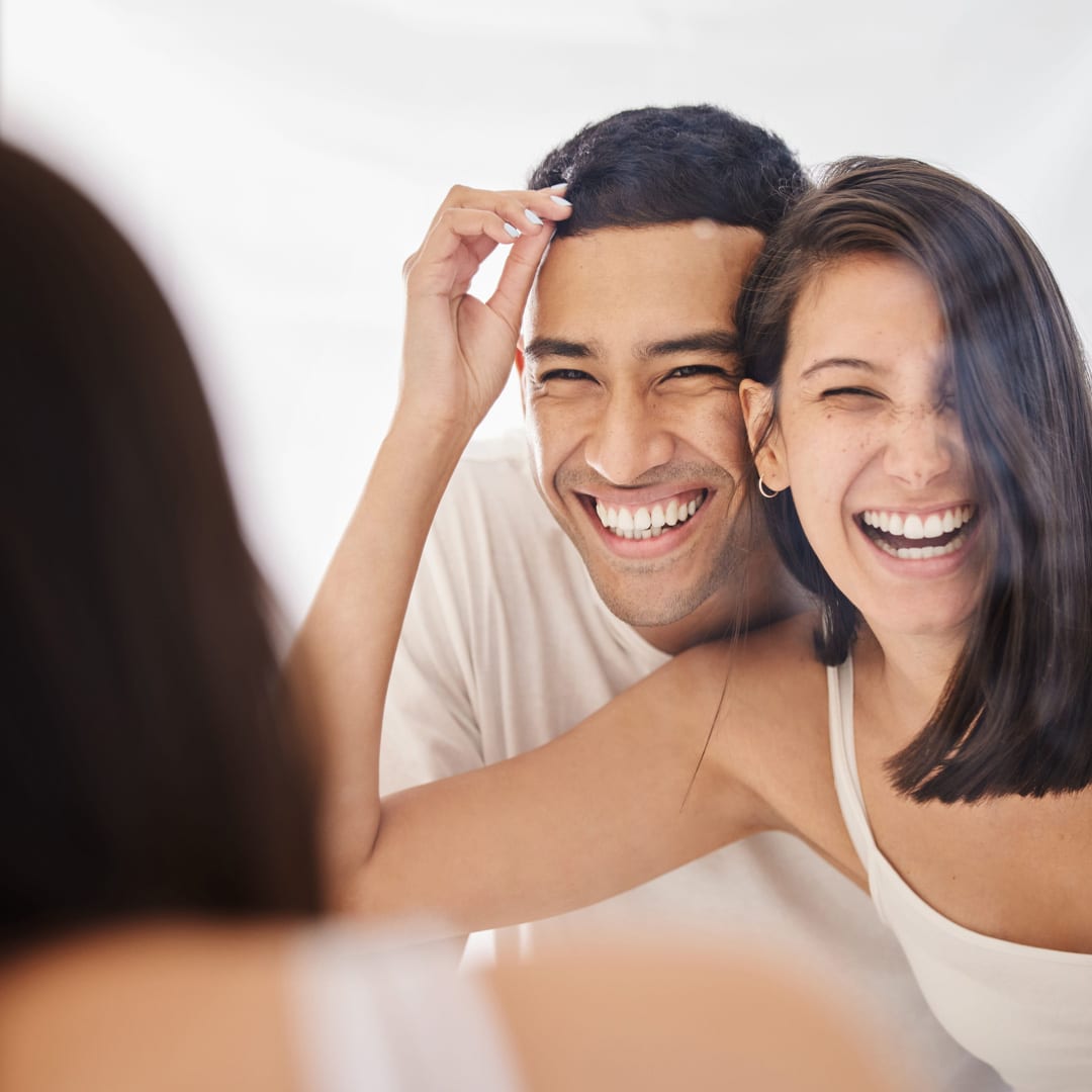 Man and woman smiling after the dentist in OKC